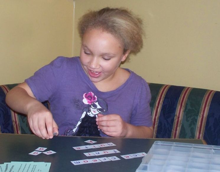 Girl building words with magnetic tiles